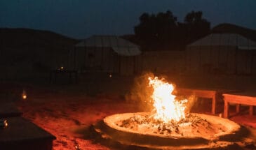 Romantic Evening In Glamping Desert Camp In Sahara, Morocco With Huge Campfire