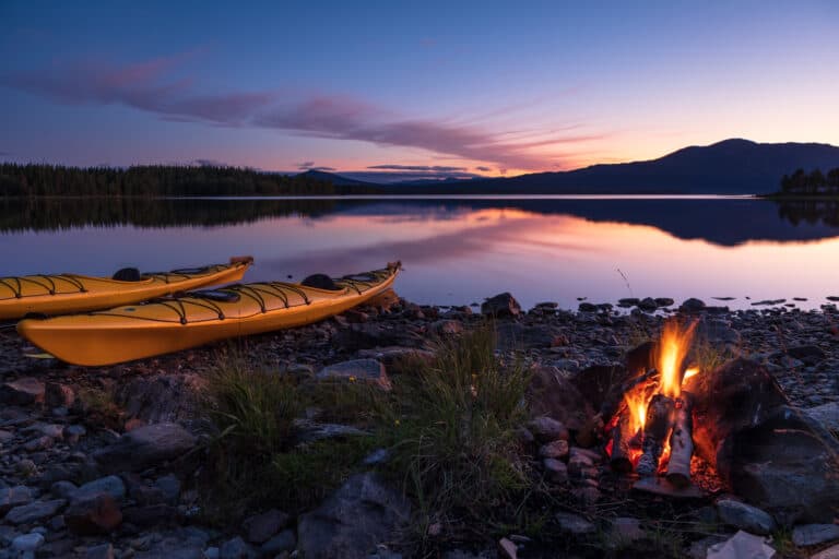 Campfire,During,Dusk,At,The,Shore,Of,A,Lake,With